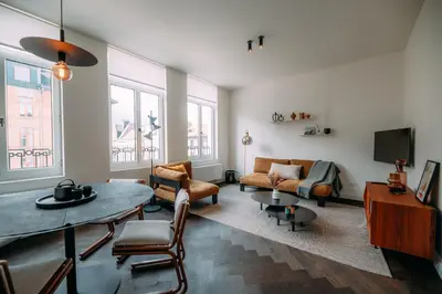 a living room with a couch and a table at Sud d'Anvers in Antwerp