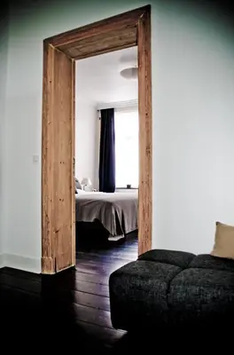 a bedroom with a bed and a large mirror at House Ninety Guesthouse in Brussels