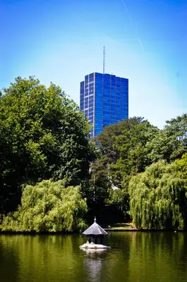 a boat with a canopy in a lake with a building at House Ninety Guesthouse in Brussels