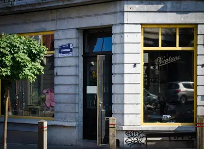 a store front with its door open on a street at House Ninety Guesthouse in Brussels