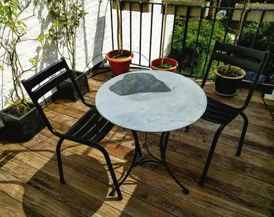 a table and two chairs on a wooden deck at House Ninety Guesthouse in Brussels