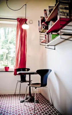 a table and chairs in a room with a window at House Ninety Guesthouse in Brussels