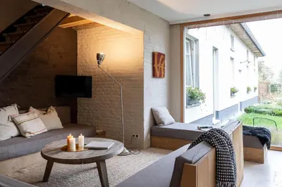 a living room with a couch and a table at Het Verblijf in Sint-Martens-Lennik