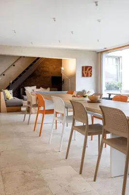 a dining room with a long table and chairs at Het Verblijf in Sint-Martens-Lennik