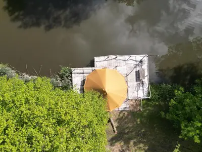 a yellow umbrella sitting in front of a building at ASILI DELUXE - Zebra in Lichtaart