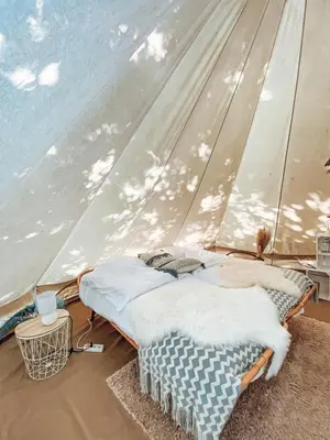 a bedroom with two beds in a tent at POLE POLE - Ijsbeer in Lichtaart