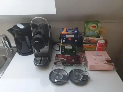 a kitchen counter with a blender and wine glasses at Spacious Loft in the Historical Centre in Ghent
