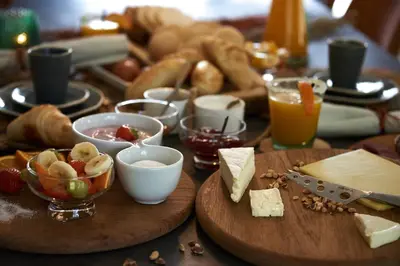 a table topped with plates of food and cheese at B&B Pura Vista in Zandhoven