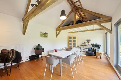 a large living room with a table and chairs at B&B Zinnen en Minnen in Herselt