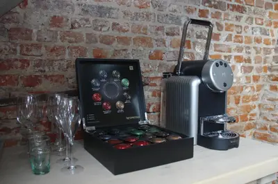 a counter with a box of chocolates and a wine glass at B&B Casa Luna Loft in Dendermonde