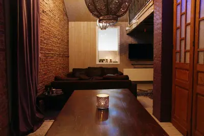 a living room with a table and a couch at B&B Casa Luna Loft in Dendermonde