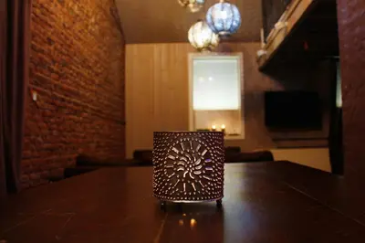 a candle sitting on top of a wooden table at B&B Casa Luna Loft in Dendermonde