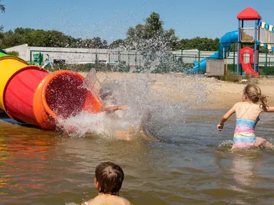 two children playing in the water at a water park at Chalet near Antwerp with Pool Access in Rijkevorsel