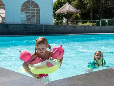 two young girls playing in a swimming pool at Chalet near Antwerp with Pool Access in Rijkevorsel