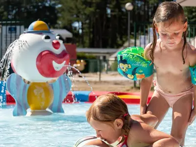 two young girls playing in the water at a pool at Chalet near Antwerp with Pool Access in Rijkevorsel