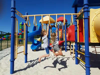 two children playing on a playground at Chalet near Antwerp with Pool Access in Rijkevorsel