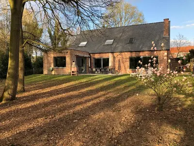 a brick house with a large yard in front of it at Hammo in Ham