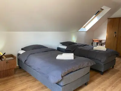 a bedroom with three beds and a couch at Hammo in Ham