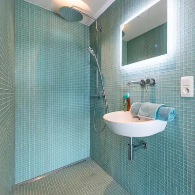 a bathroom with a sink and a shower at La Vista in Tervuren
