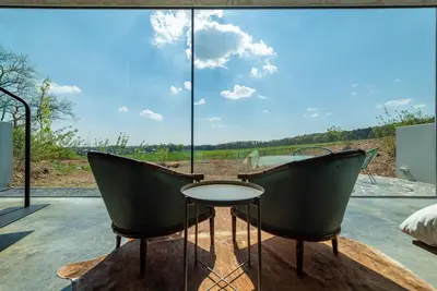 a room with two chairs and a table in front of a window at La Vista in Tervuren