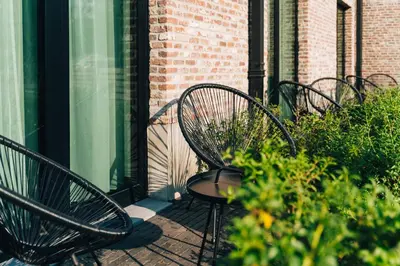 a group of benches sitting on a patio at Factory Hotel in Beveren