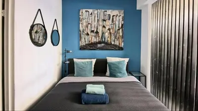 a bedroom with a large bed with blue walls at Opera - Central Station, Flixbus, Airport Shuttle in Antwerp