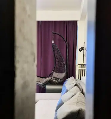 a bedroom with a chair with a shoe in the window at Opera - Central Station, Flixbus, Airport Shuttle in Antwerp
