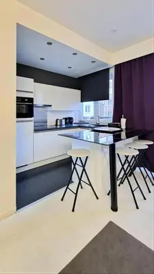 a kitchen with a table and some chairs in it at Opera - Central Station, Flixbus, Airport Shuttle in Antwerp