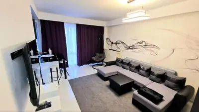 a living room with a couch and a tv at Opera - Central Station, Flixbus, Airport Shuttle in Antwerp