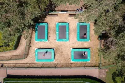 an overhead view of a building with four swimming pools at Recreatie- en Natuurpark Keiheuvel in Balen