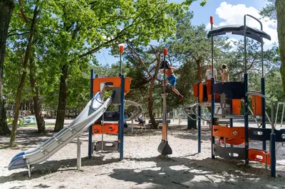 a playground with a slide and people on it at Recreatie- en Natuurpark Keiheuvel in Balen