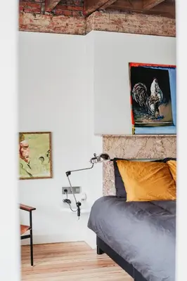 a bedroom with a bed and paintings on the wall at Huis Hector Mechiels ROOM in Sint-Niklaas