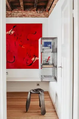a pair of shoes in a room with a red painting at Huis Hector Mechiels ROOM in Sint-Niklaas