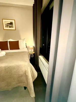 a bedroom with a bed and a flat screen tv at Luxury Suites Diamond by Rikas Hotels in Antwerp