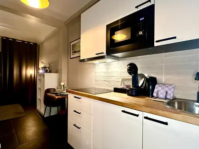 a kitchen with white cabinets and a sink at Luxury Suites Diamond by Rikas Hotels in Antwerp