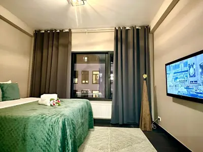 a bedroom with a bed and a flat screen tv at Luxury Suites Diamond by Rikas Hotels in Antwerp