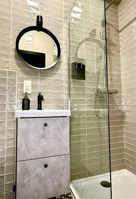 a bathroom with a shower and a sink and a mirror at Luxury Suites Diamond by Rikas Hotels in Antwerp