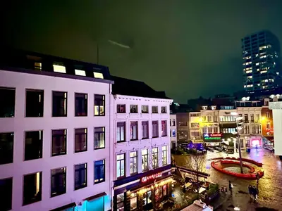 a view of a city at night with buildings at Luxury Suites Diamond by Rikas Hotels in Antwerp