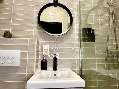 a bathroom with a sink and a mirror at Luxury Suites Diamond by Rikas Hotels in Antwerp