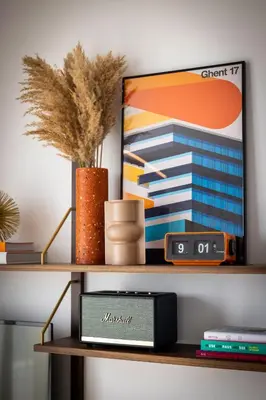 a shelf with a clock and a picture on it at Yalo Urban Boutique Hotel Gent in Ghent