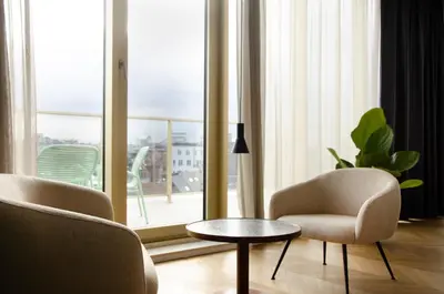 a living room with two chairs and a table at Yalo Urban Boutique Hotel Gent in Ghent