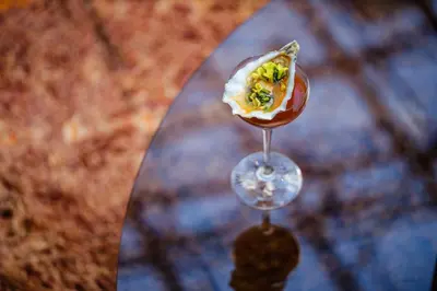 a wine glass with food on top of a table at Yalo Urban Boutique Hotel Gent in Ghent
