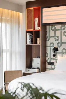 a bedroom with a bed and a book shelf at Yalo Urban Boutique Hotel Gent in Ghent