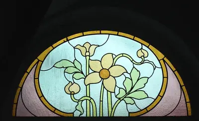 a stained glass window with a flower on it at Atlas B&B in Ghent