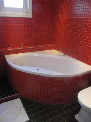 a red tiled bathroom with a tub and a toilet at Atlas B&B in Ghent