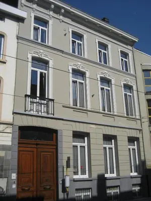 a large building with a brown door and windows at Atlas B&B in Ghent