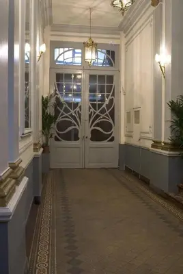 a hallway with a large door in a building at Atlas B&B in Ghent