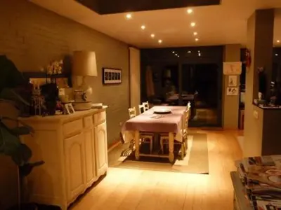 a kitchen with a table in the middle of a room at B&B Sparrow's Nest in Ghent