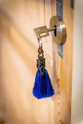 a blue tassel hanging from a door knob at Adamas B&B in Dendermonde