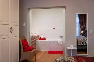 a bathroom with a bath tub and a sink at Adamas B&B in Dendermonde
